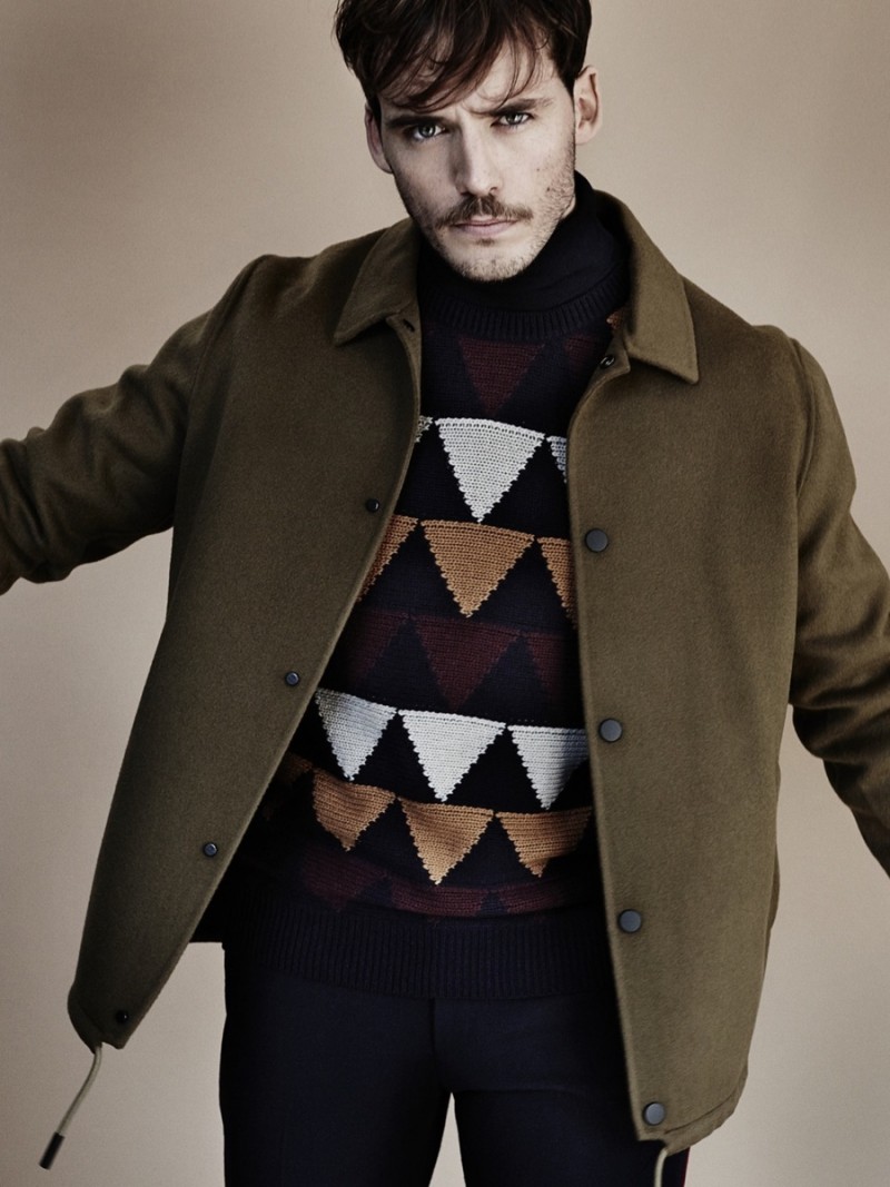 Sam Claflin wears jacket Acne Studios and sweater Valentino.