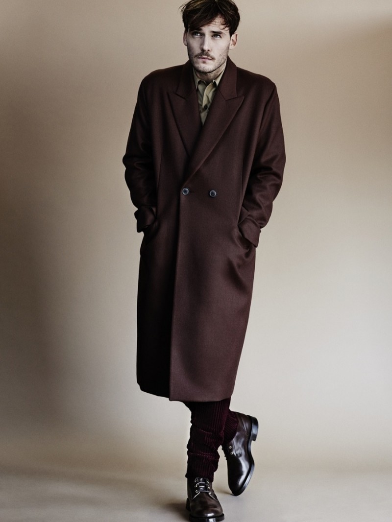 Sam Claflin wears coat Paul Smith, shirt Prada, boots Trickers and trousers Burberry.