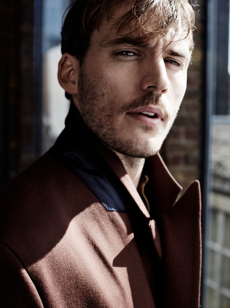 Sam Claflin wears coat Paul Smith.