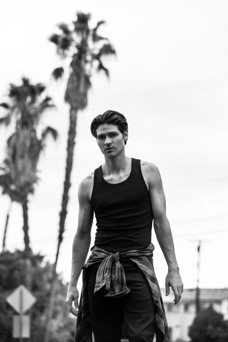 Will Peltz embraces classic Calvin Klein style in a black wifebeater with jeans and a shirt tied around his waist.