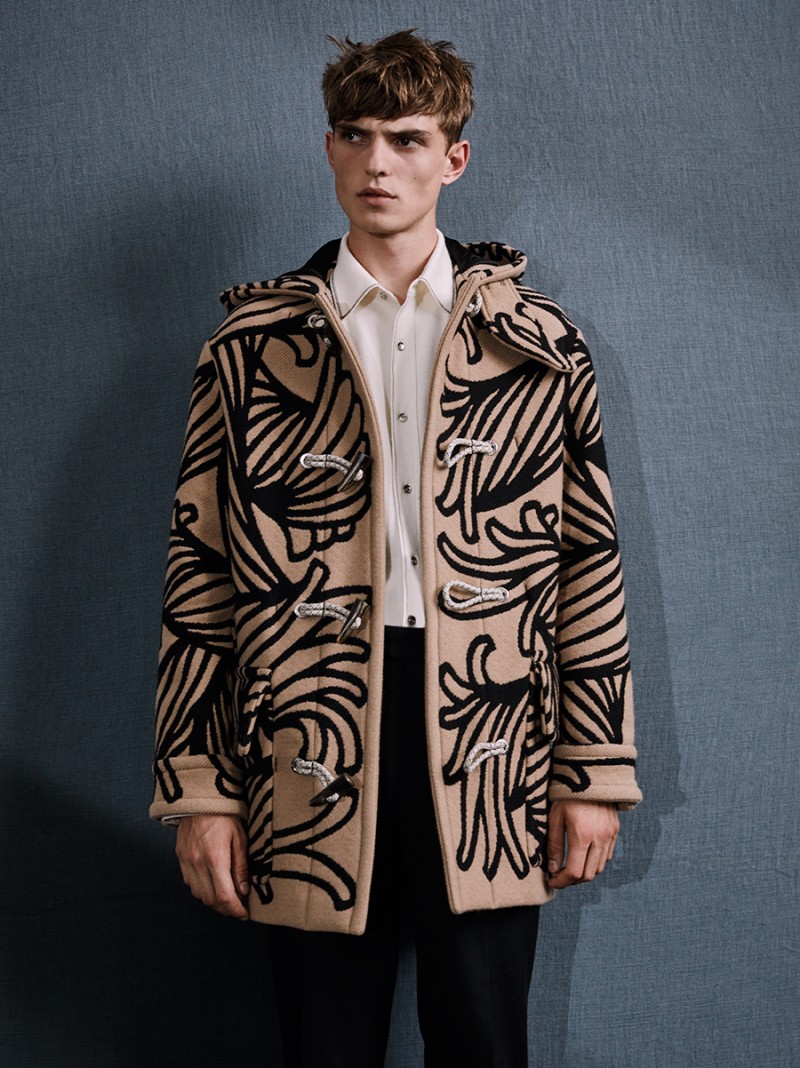 Guerrino wears graphic print duffle coat Louis Vuitton.