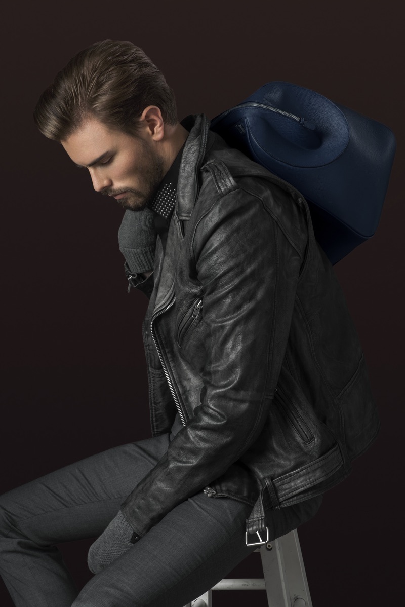 Andreas wears leather jacket Black Dust, shirt Hugo Boss, gloves stylist's own, trousers Ermenegildo Zegna and bag Serapian.