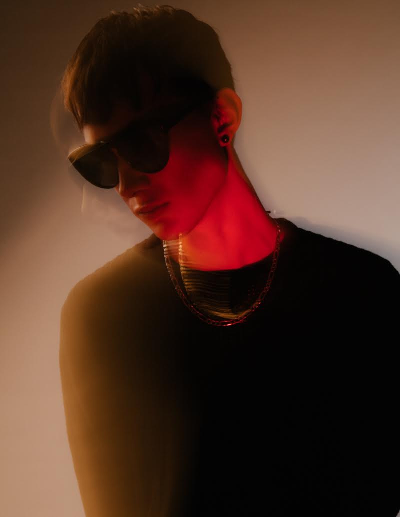 Marius wears sweater J.Lindeberg, sunglasses Alexander Wang, Tahitian black pearl earrings and silver chain necklace Birks.