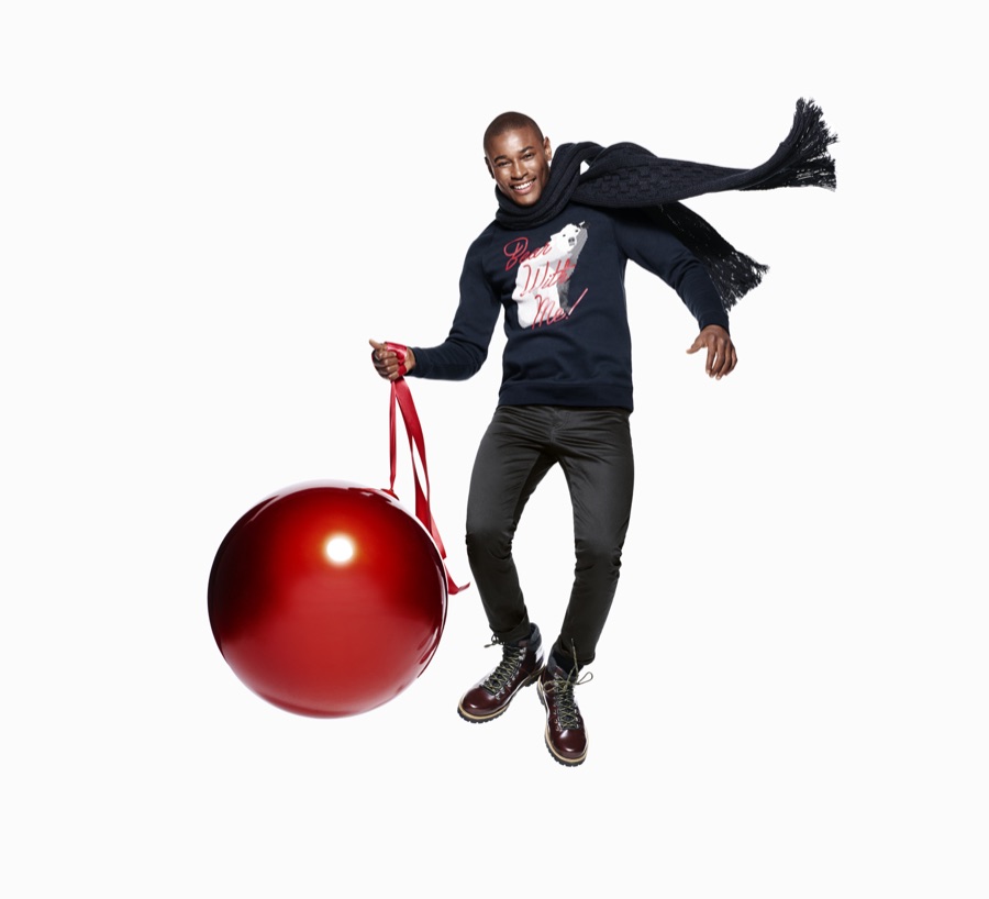 Roger Dupe is ready to trim the tree as he leaps for a festive image from H&M.