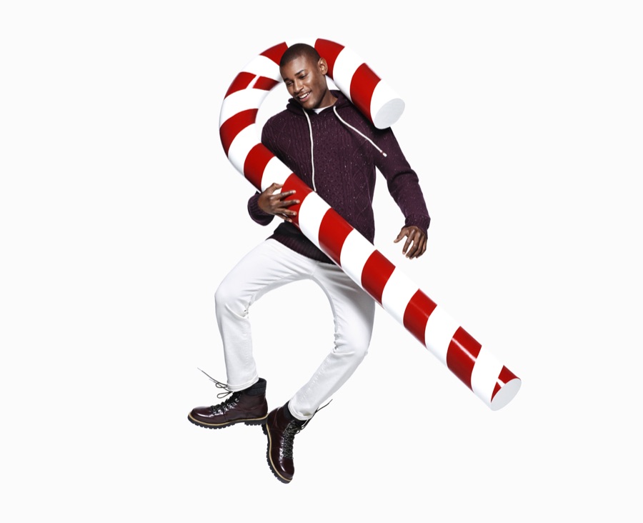 Roger Dupe poses with an oversized candy cane for H&M's holiday 2015 campaign.