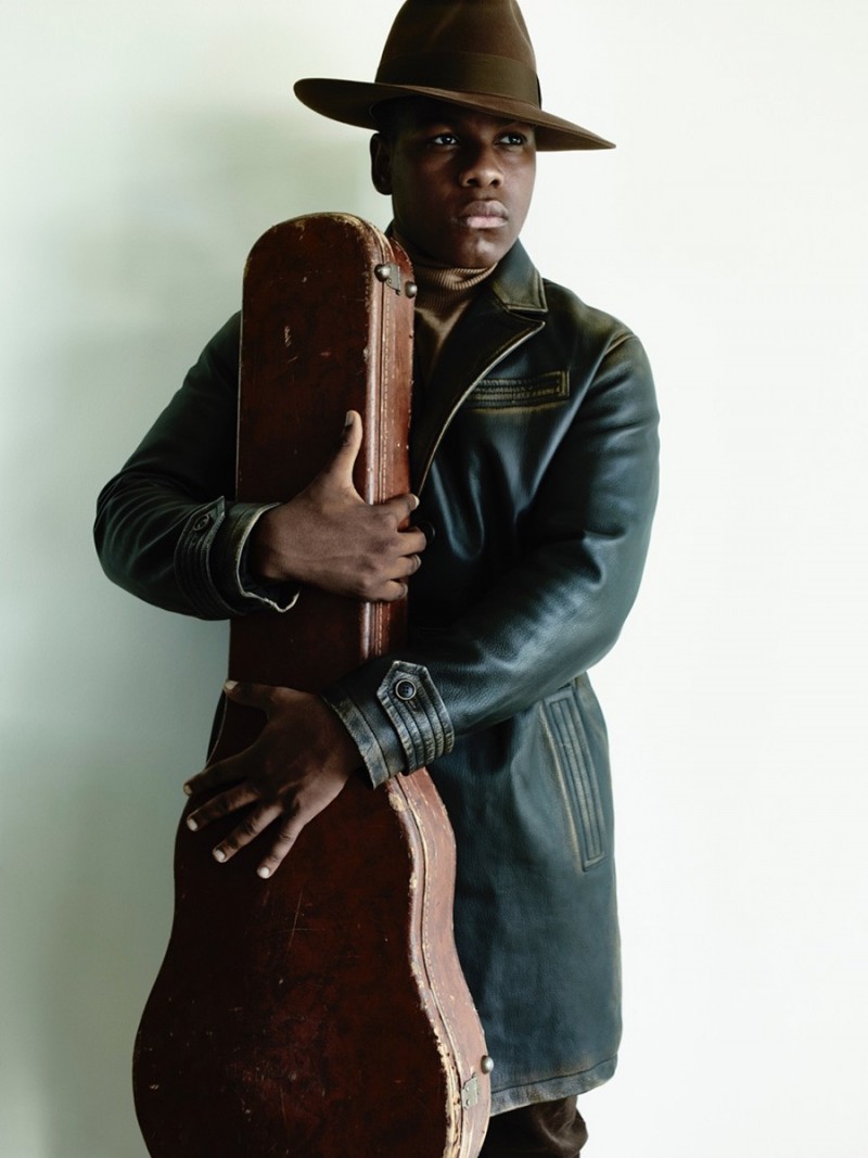 Clutching on to a guitar case, John Boyega is photographed for British GQ.