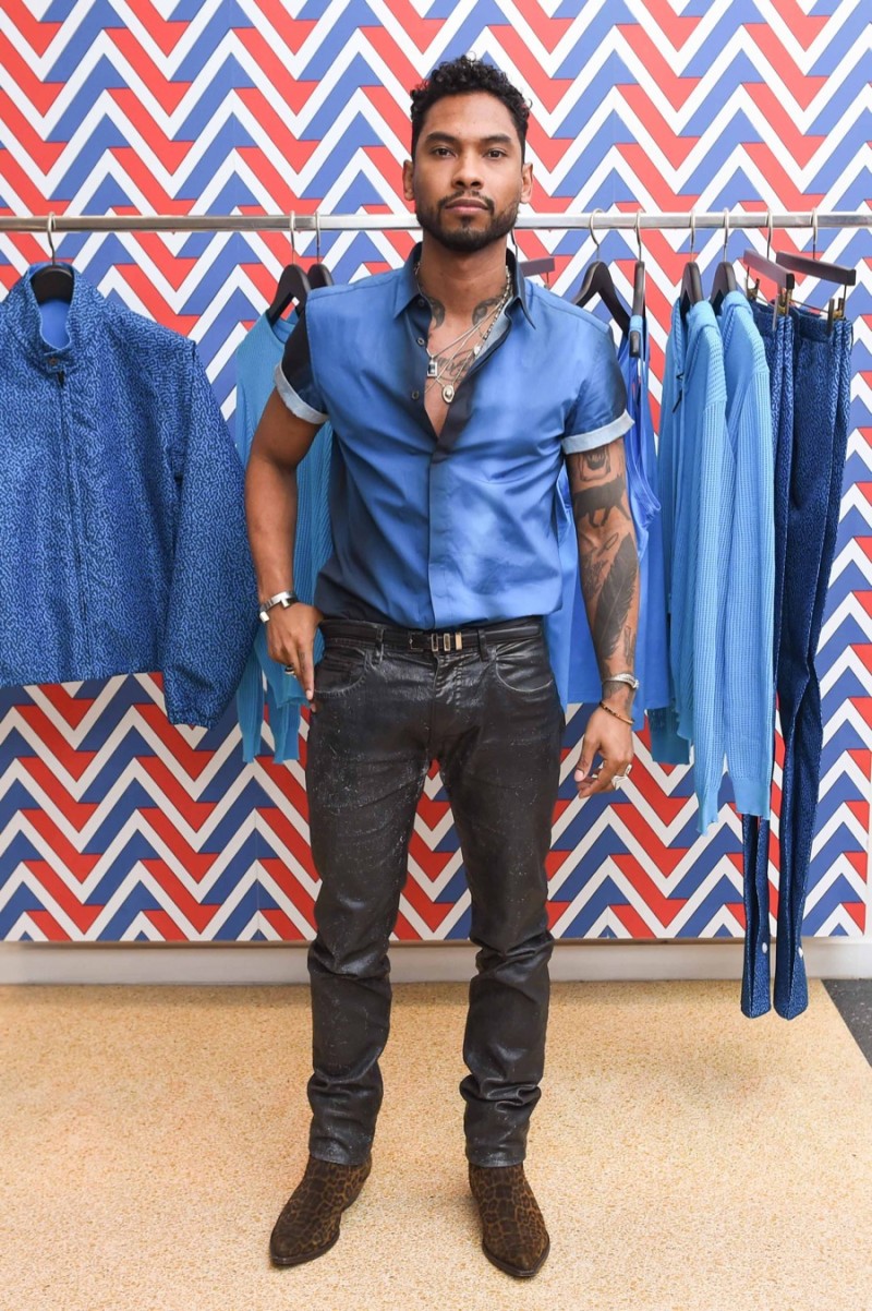 Attending Art Basel in Miami, Florida, Miguel wears singer Miguel wears a blue degrade short-sleeve shirt and slim-fit pants from Calvin Klein Collection.