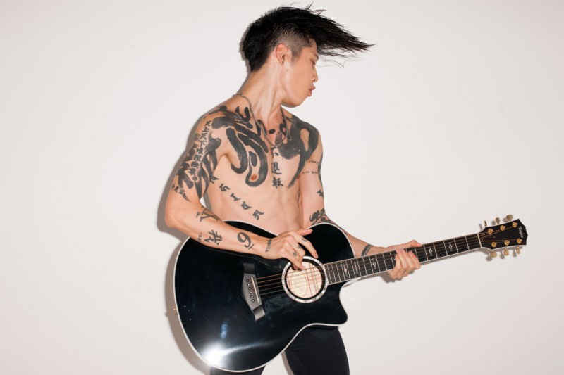 Miyavi rocks out shirtless with his guitar.