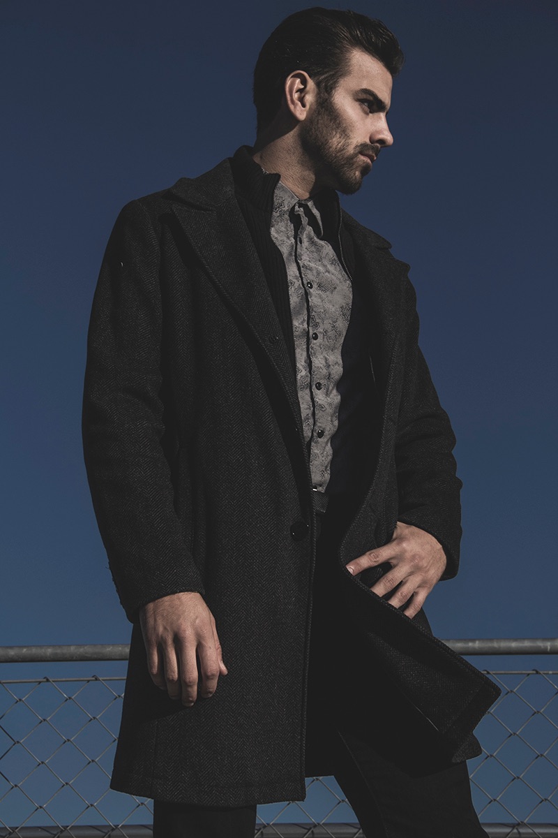 Nyle DiMarco wears coat Kenneth Cole, shirt INC and pants H&M.