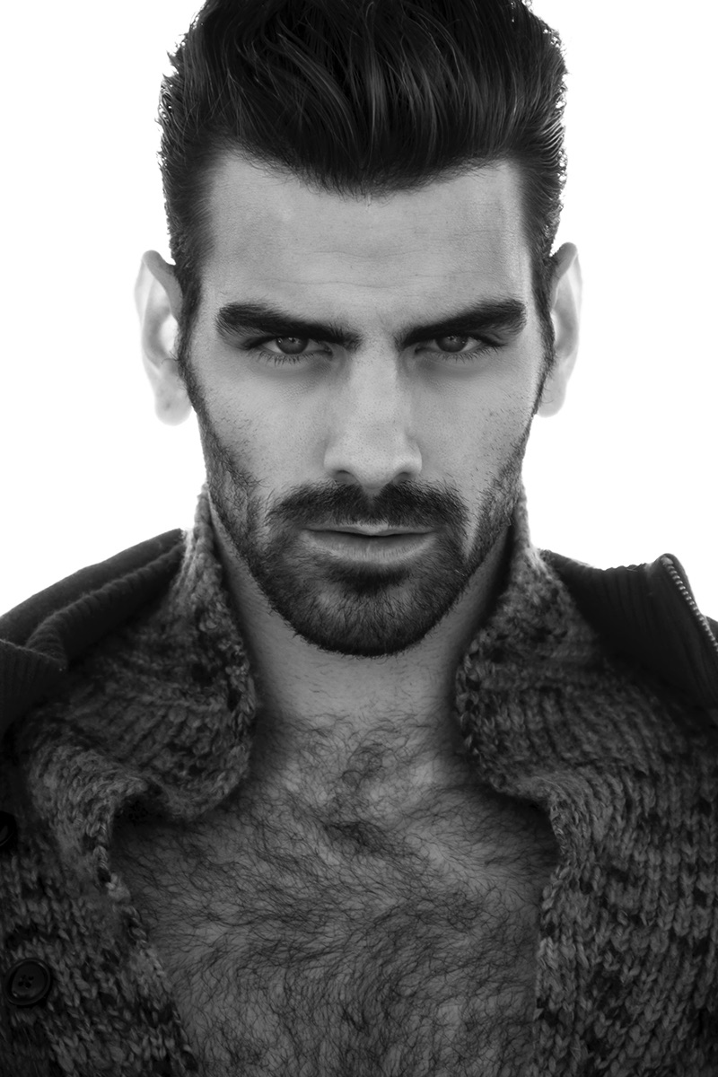 Nyle DiMarco wears coat Kenneth Cole and cardigan Todd Snyder.