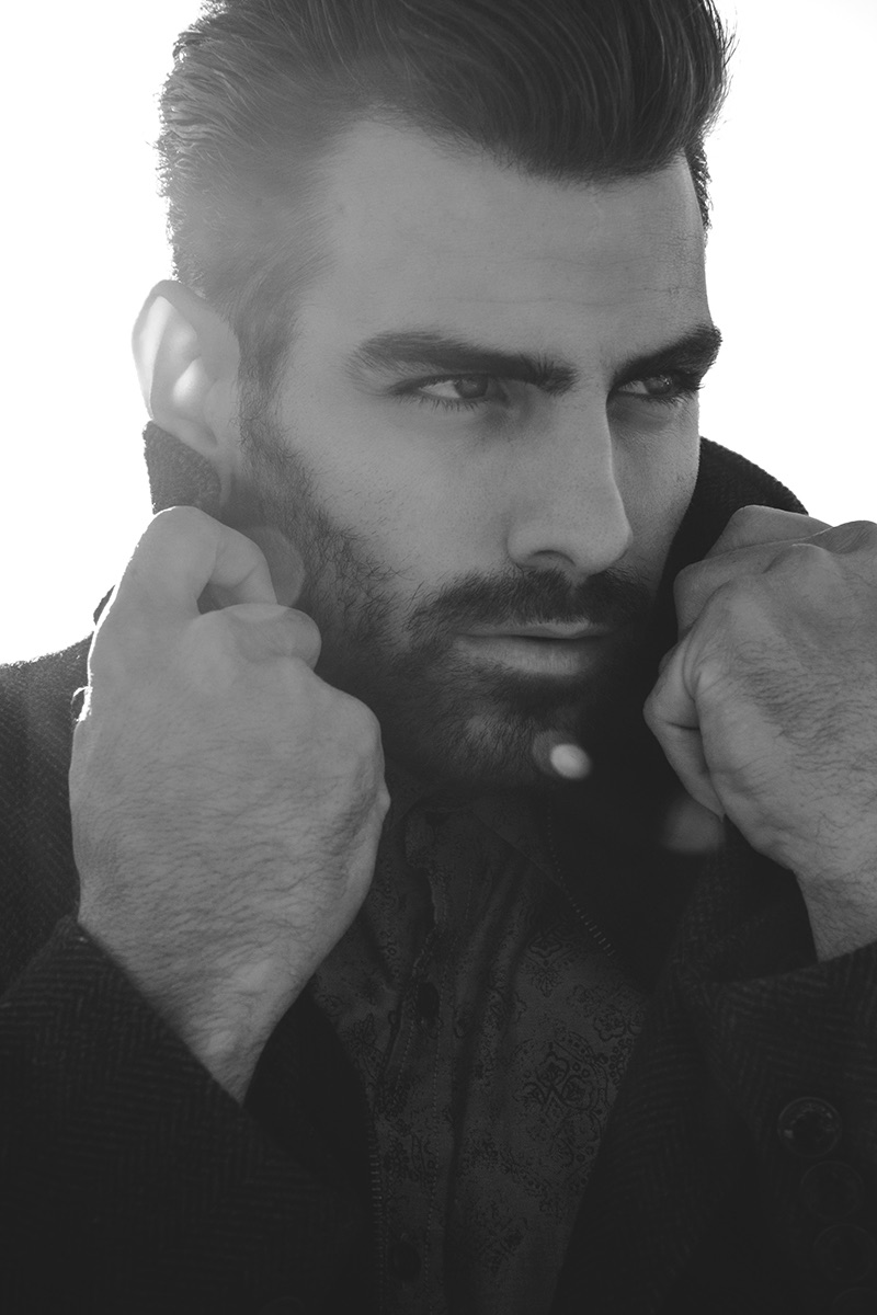 Nyle DiMarco wears coat Kenneth Cole.