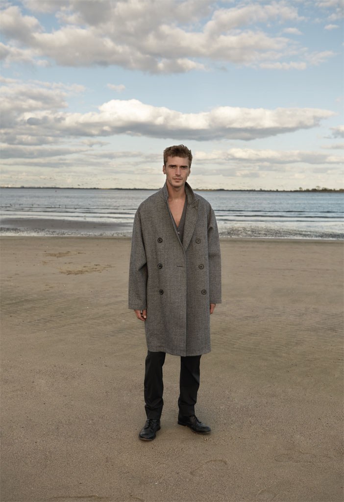 Clément Chabernaud is captured on the beach in an oversized winter coat.