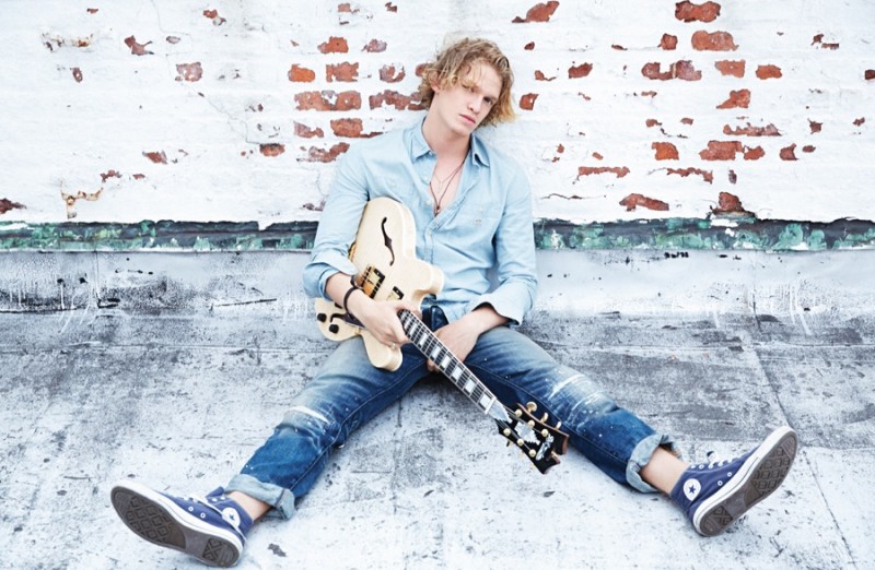 Cody Simpson wears necklace Starling Silver, vintage bracelet Cody's own, sneakers Converse, necklace and ring Mara Carrizo Scalise, shirt and jeans Ralph Lauren Denim & Supply.