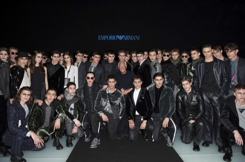 Designer Giorgio Armani poses for a photograph with the models who walked Emporio Armani's fall-winter 2016 show.