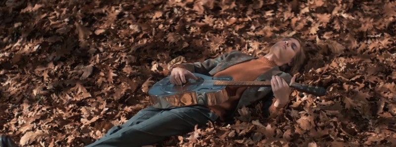 Appearing in Etro's fall 2016 film, Marcel Castenmiller plays the guitar in a bed of leaves.