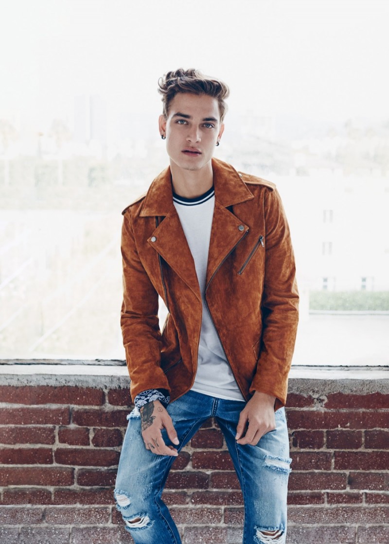 Brazilian model Jonathan Bellini dons a brown biker jacket and ripped distressed denim jeans for Forever 21's spring 2016 campaign.