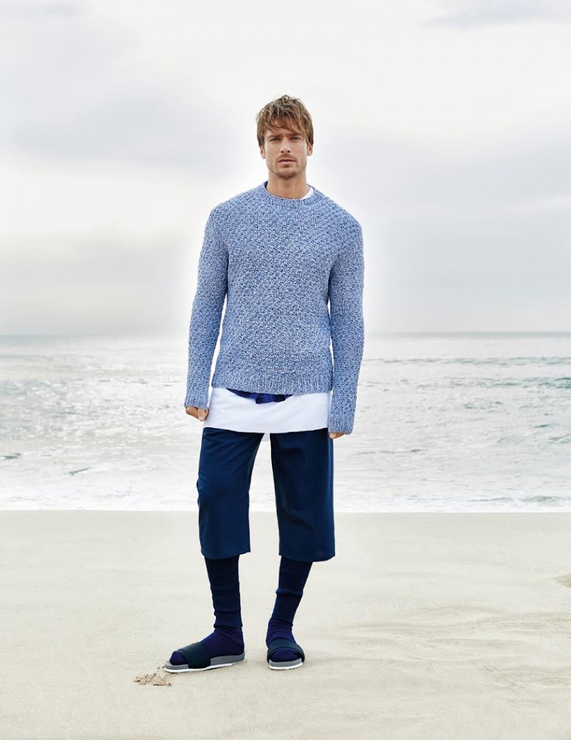 Photographed by Branislav Simoncik, Jason Morgan poses on a picturesque beach for GQ Portugal.