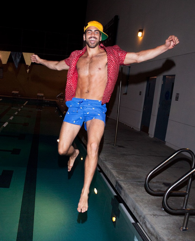 Nyle DiMarco is all smiles in a Brixton cap worn with an Obey Clothing shirt and Etro swim shorts.