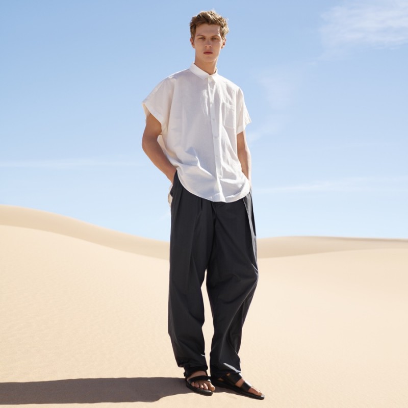 Tim Schuhmacher dons a sleek white short-sleeve shirt for COS' spring-summer 2016 campaign.