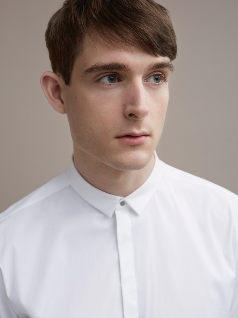 Model Karl Morrall connects with COS, wearing a modern Press Stud Collar Shirt.