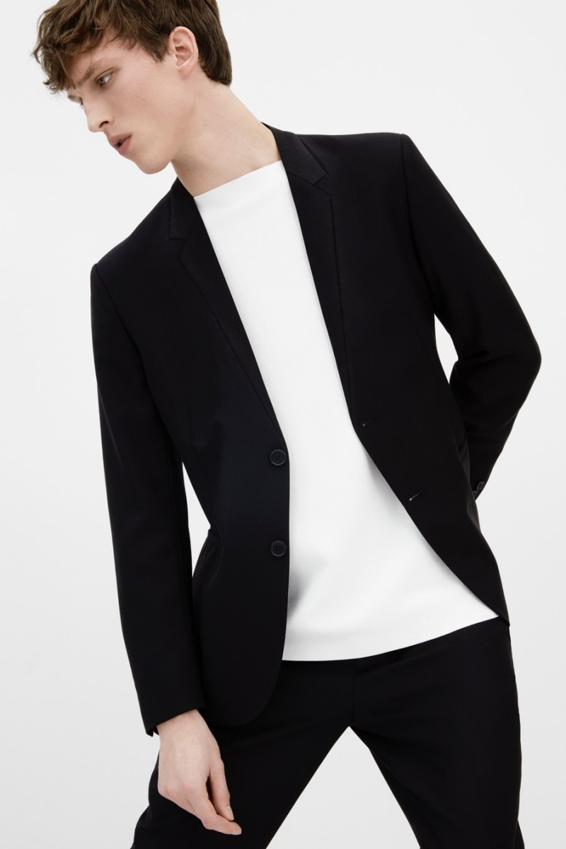Malthe Lund Madsen wears a COS blazer, slit-neck jumper and slim wool trousers.