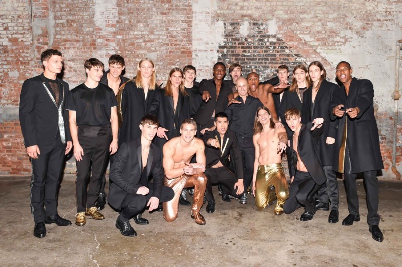 Calvin Klein Collection men's creative director Italo Zucchelli poses with models at the label's New York Fashion Week: Men presentation.