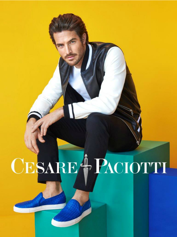 Model Justice Joslin sports a leather varsity jacket and blue slip-on sneakers for Cesare Paciotti's spring-summer 2016 campaign.