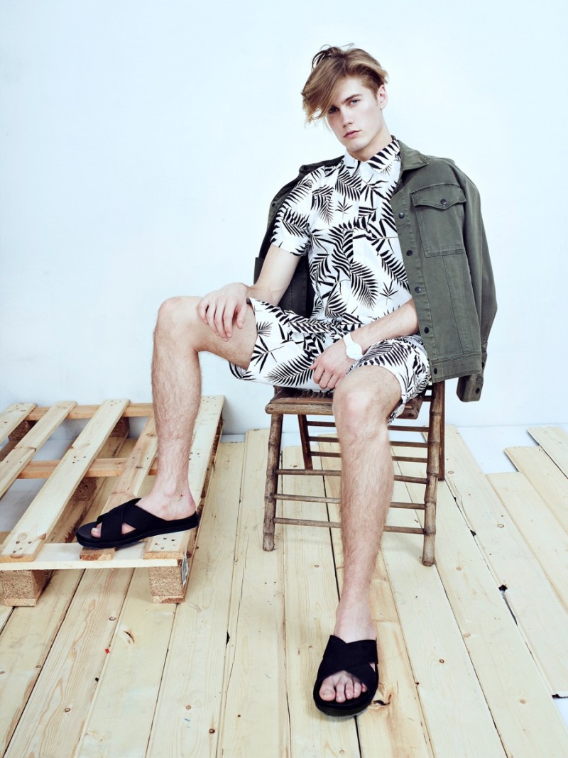 Neels wears jacket Michael Stars, watch stylist's own, sandals Vince, palm tree print shirt and shorts Control Sector.