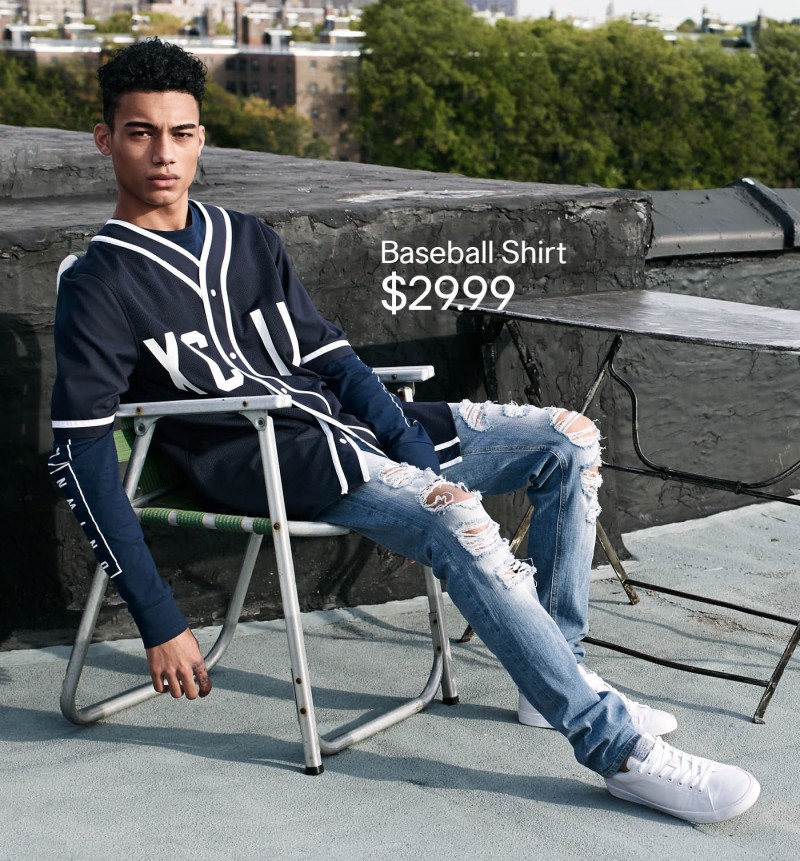 H&M pairs its baseball shirt with ripped, distressed, skinny denim jeans.