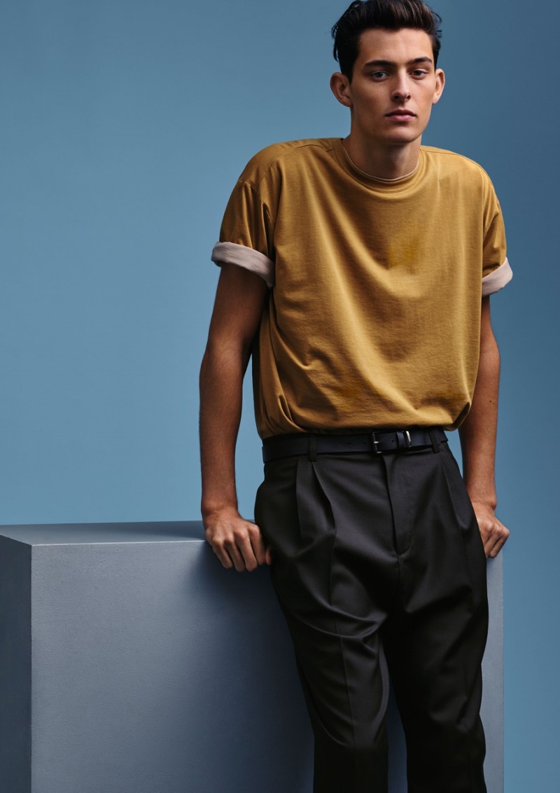Rhys Pickering sports a t-shirt with rolled sleeves and front pleated trousers from H&M Studio.