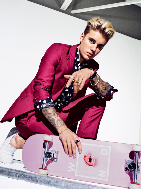 Justin Bieber rocks a fuchsia suit from Topman with a polka dot Saint Laurent shirt.