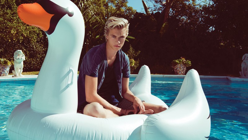 Starring in Penshoppe's spring 2016 campaign, Lucky Blue Smith poses on an inflatable swan.