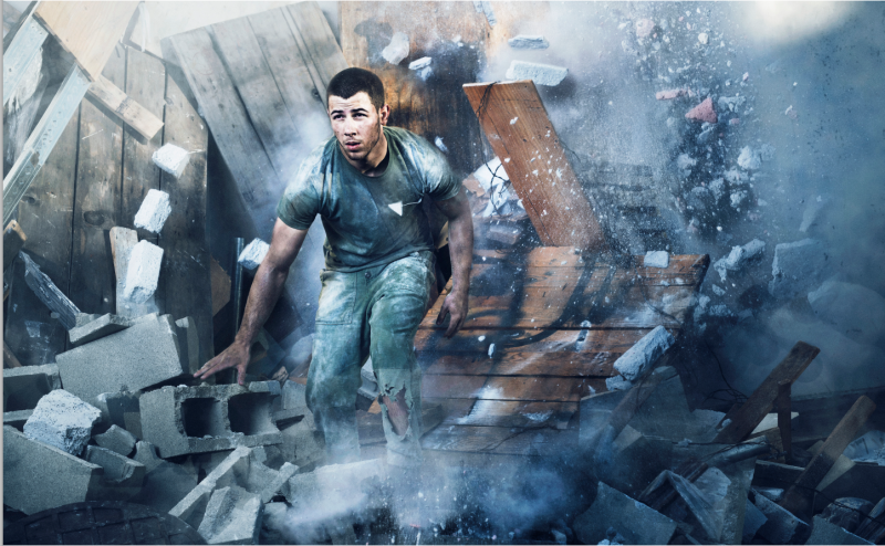 Photographed for Complex magazine, Nick Jonas breaks through a wall in an intense photo.