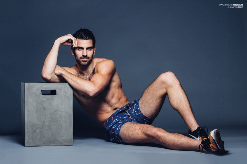 Nyle DiMarco poses in Thorsun swim shorts for BuzzFeed.