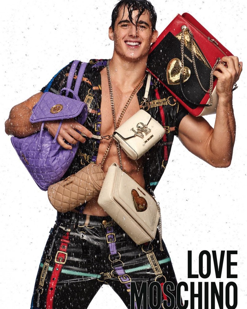 Pietro Boselli is all smiles as he poses with bags for Love Moschino's spring-summer 2016 campaign.
