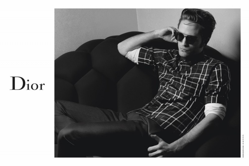 Robert Pattinson relaxes in a pair of sunglasses for Dior Homme's fall 2016 campaign.