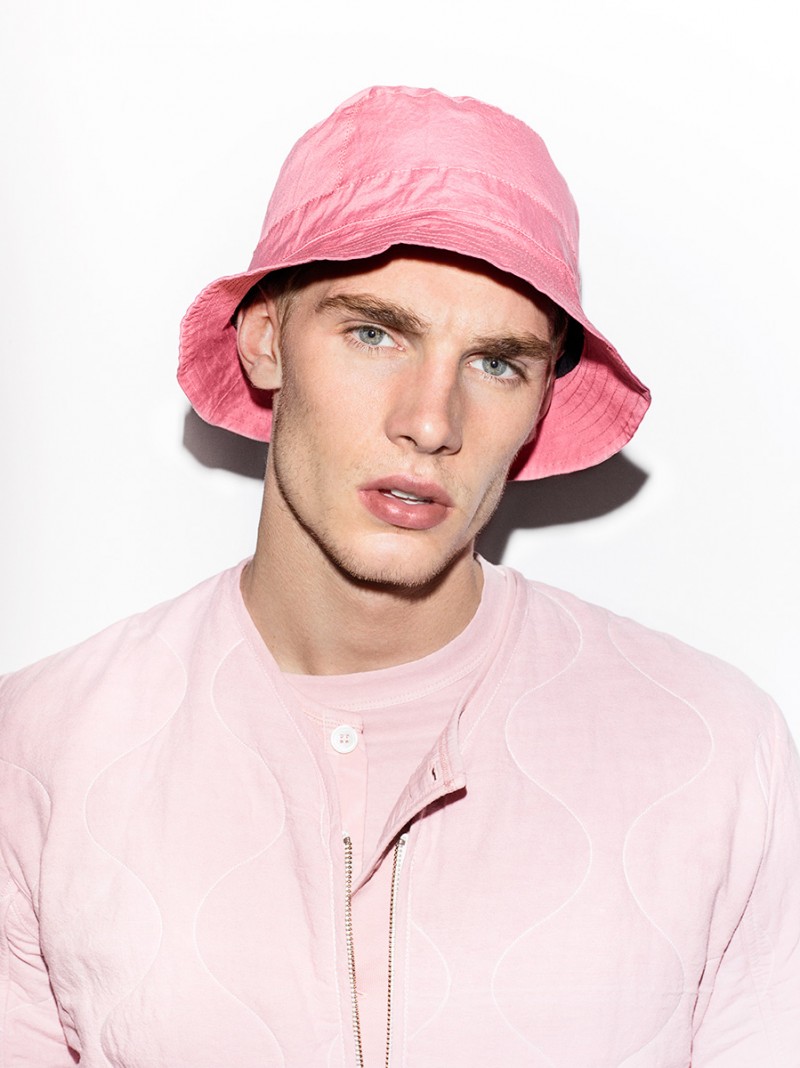 Tommy Marr is handsome in pink, wearing a spring Our Legacy look, topped off with a bucket hat.