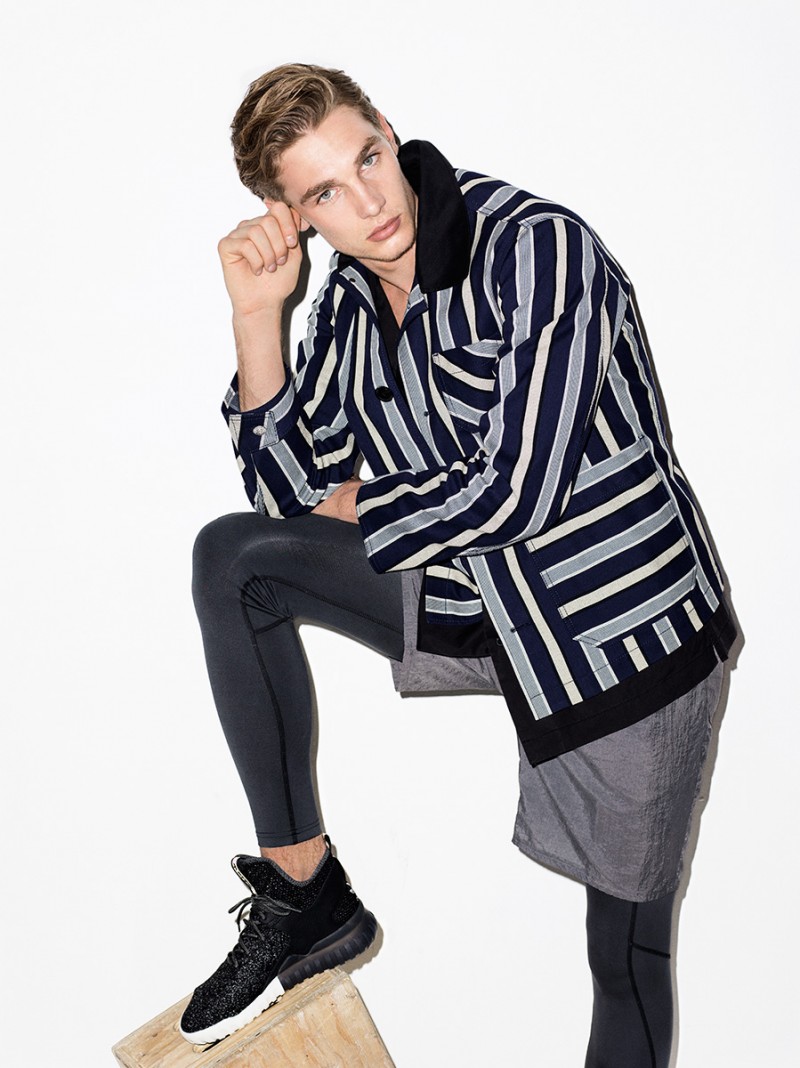 Going sporty in leggings and Tiger of Sweden shorts, Tommy Marr completes his look with a stripe jacket from Acne Studios.