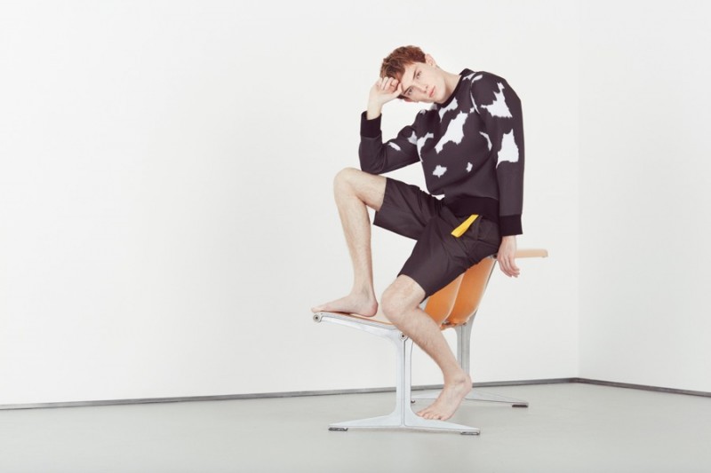 Theo George wears neoprene sweatshirt Neil Barrett and shorts with belt detailing Jil Sander.