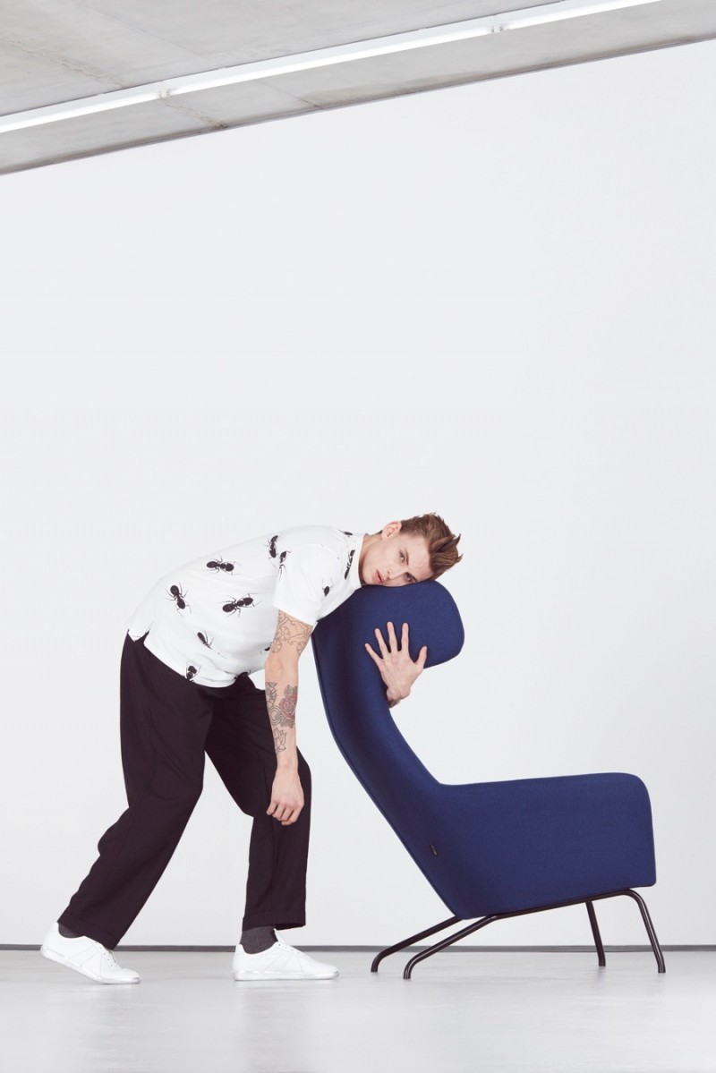 Lewis Chesson-Grieve wears sneakers Maison Margiela, trousers and printed t-shirt Paul Smith.