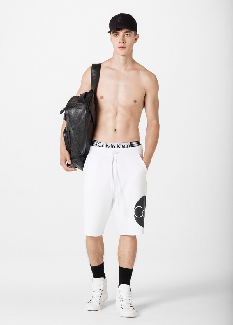 Pedro Bertolini sports Calvin Klein gym shorts with a circular logo.