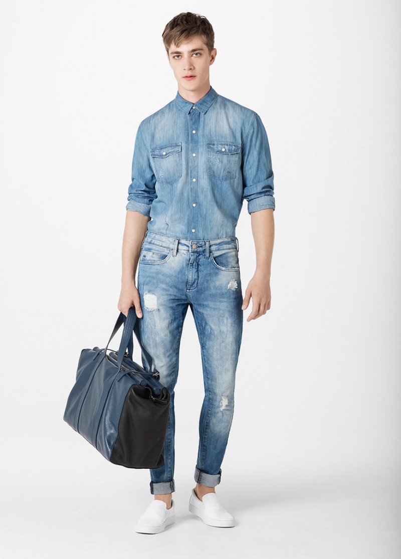 Pedro Bertolini doubles down on denim in a fitted shirt and distressed jeans.