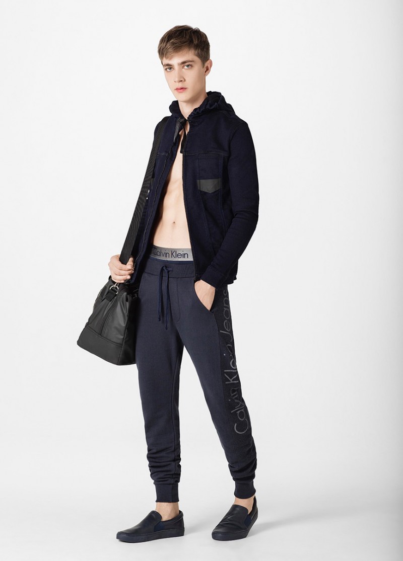 Pedro Bertolini models logo joggers from Calvin Klein Jeans with a lightweight jacket.