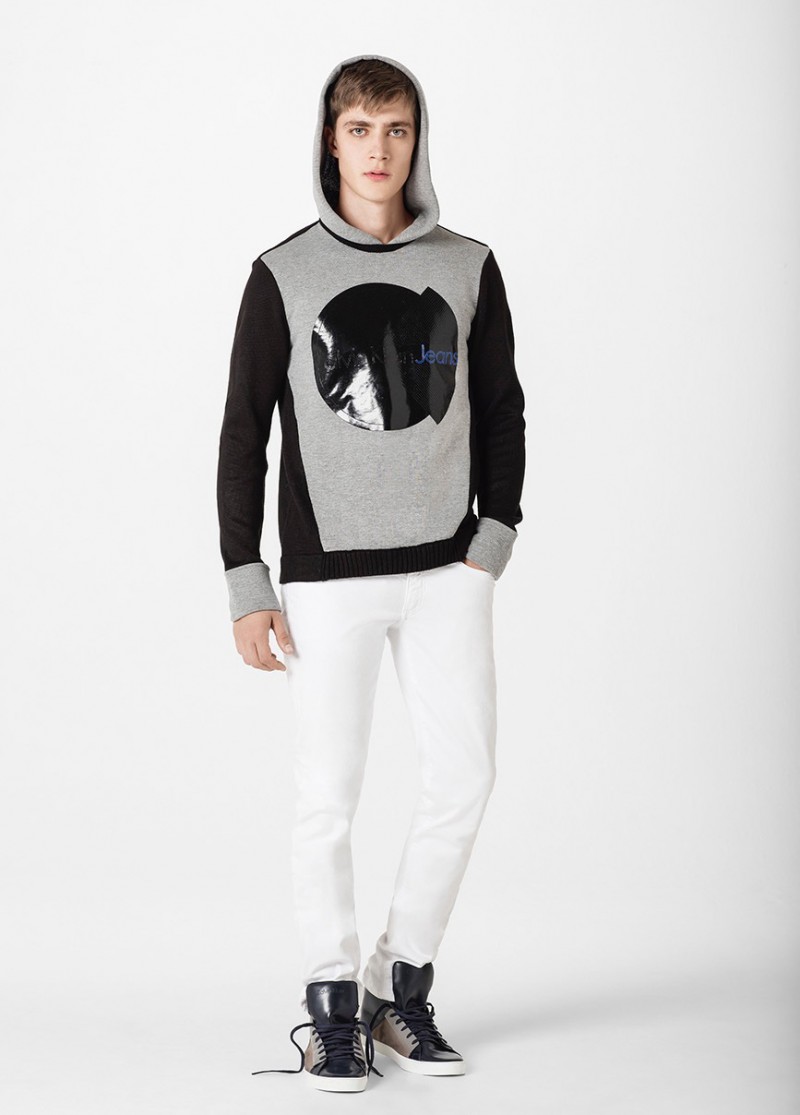 Pedro Bertolini is pictured in a Calvin Klein Jeans hooded sweatshirt with white jeans.
