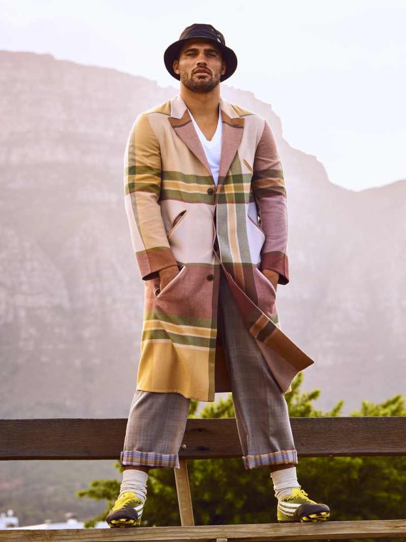 Sporting a bucket hat, Damian de Allende is a style standout in a plaid coat from Ermenegildo Zegna Couture.