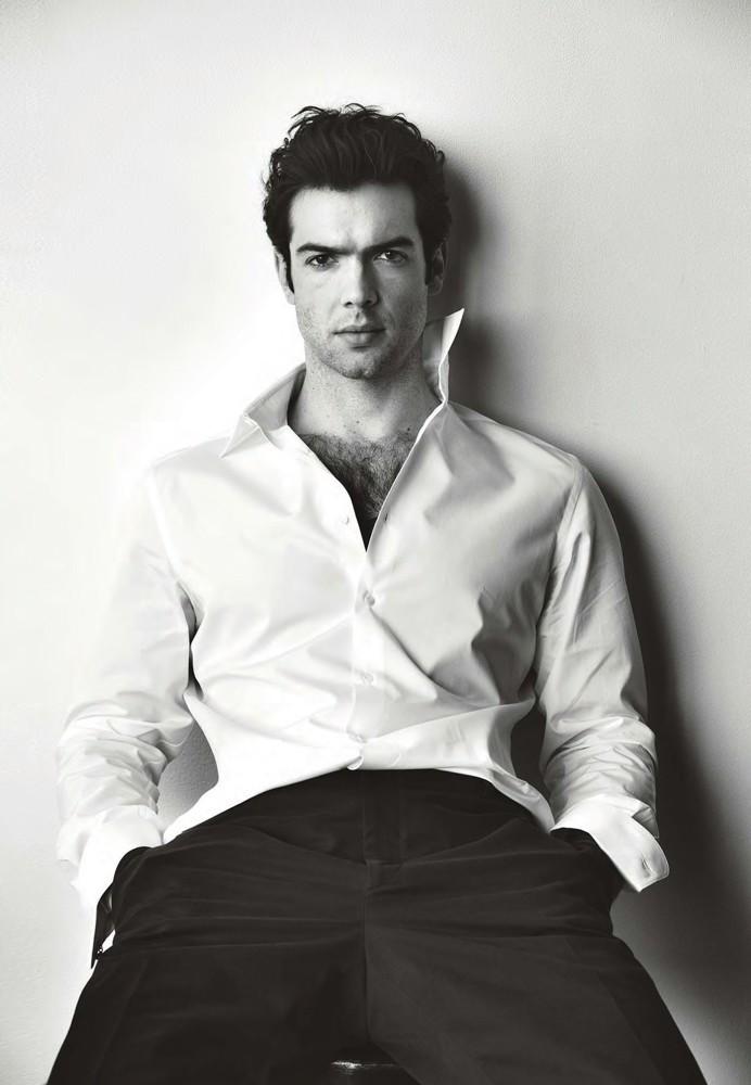 Ethan Peck dons a classic white dress shirt with trousers for his Maxim photo shoot.