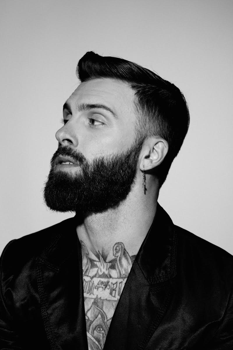 Levi Stocke embraces a smooth slicked hairstyle.