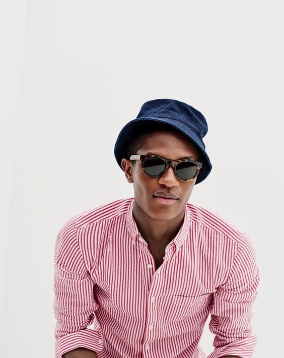 J.Crew men’s slim seersucker shirt in red stripe, Japanese cotton bucket hat in indigo and Sam sunglasses.