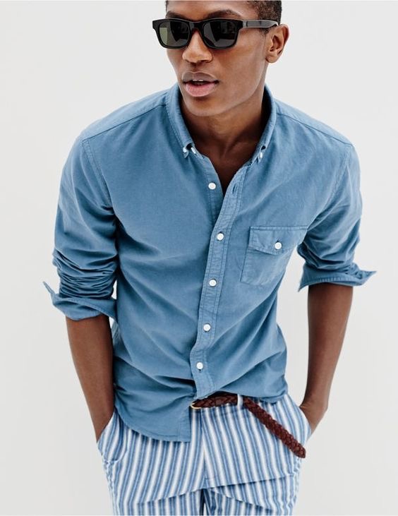 J.Crew men’s slim lightweight garment-dyed oxford shirt, Bowery slim pant in variegated-stripe cotton, Irving sunglasses and braided leather belt.
