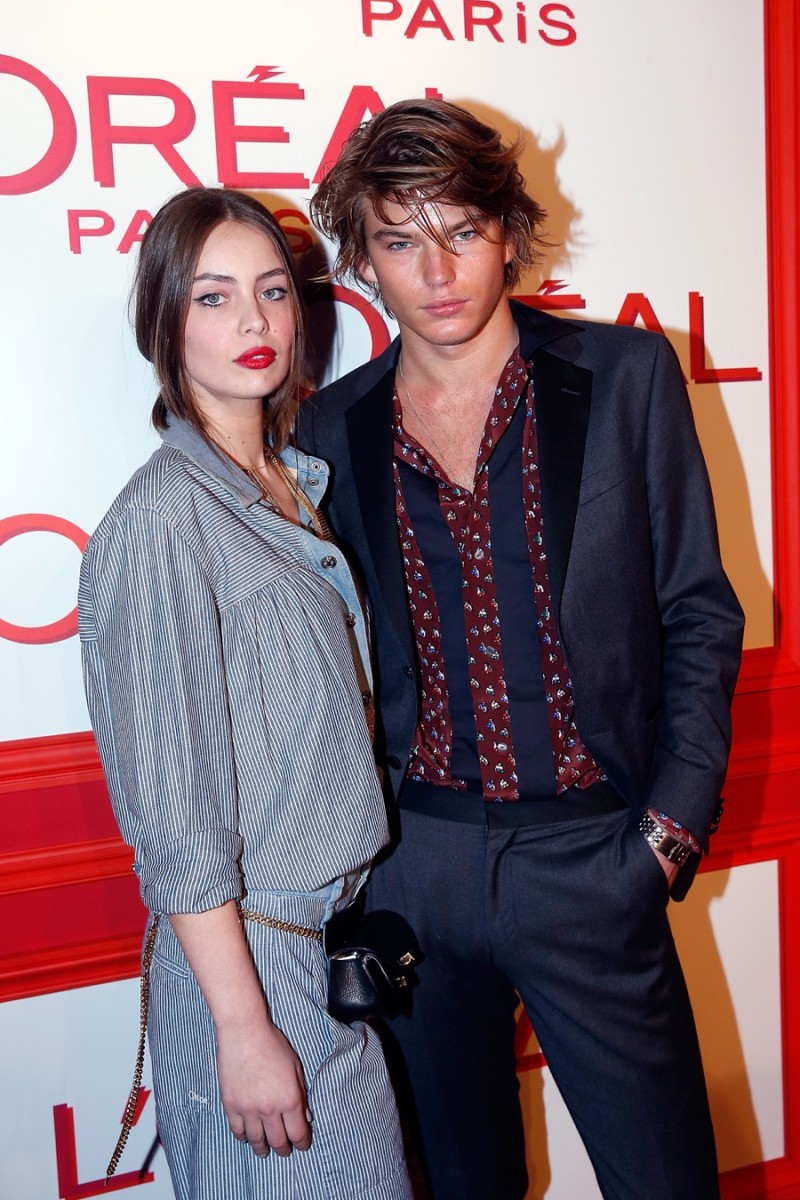 Posing with Marie-Ange Casta, Jordan Barrett attends the L'Oreal Red Obsession Party during Paris Fashion Week.